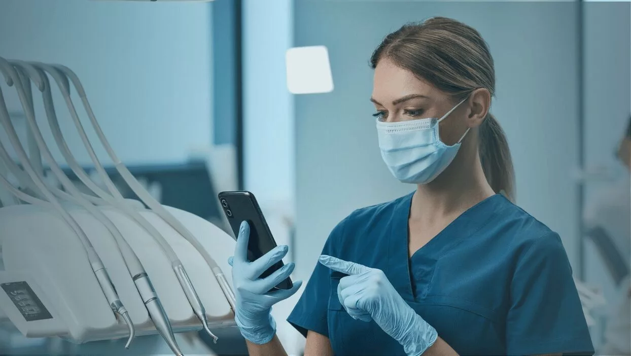 Dental Hygienist Looking at her phone